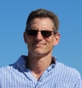 Matthew Herbst headshot with blue background