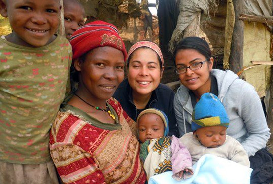 UC San Diego students posing with family in Tanzania, Africa