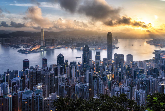 Hong Kong skyline and harbor at sunset / photo by Ryan McManimie, unsplash.com/@ryanmc